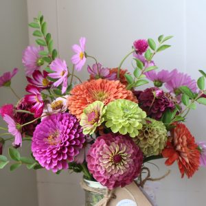 Purple and coral summer zinnia arrangement